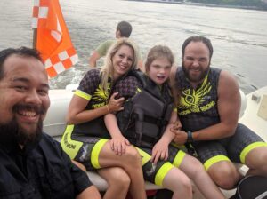 Chris and Michelle Ray with Addie on the boat in the TN River